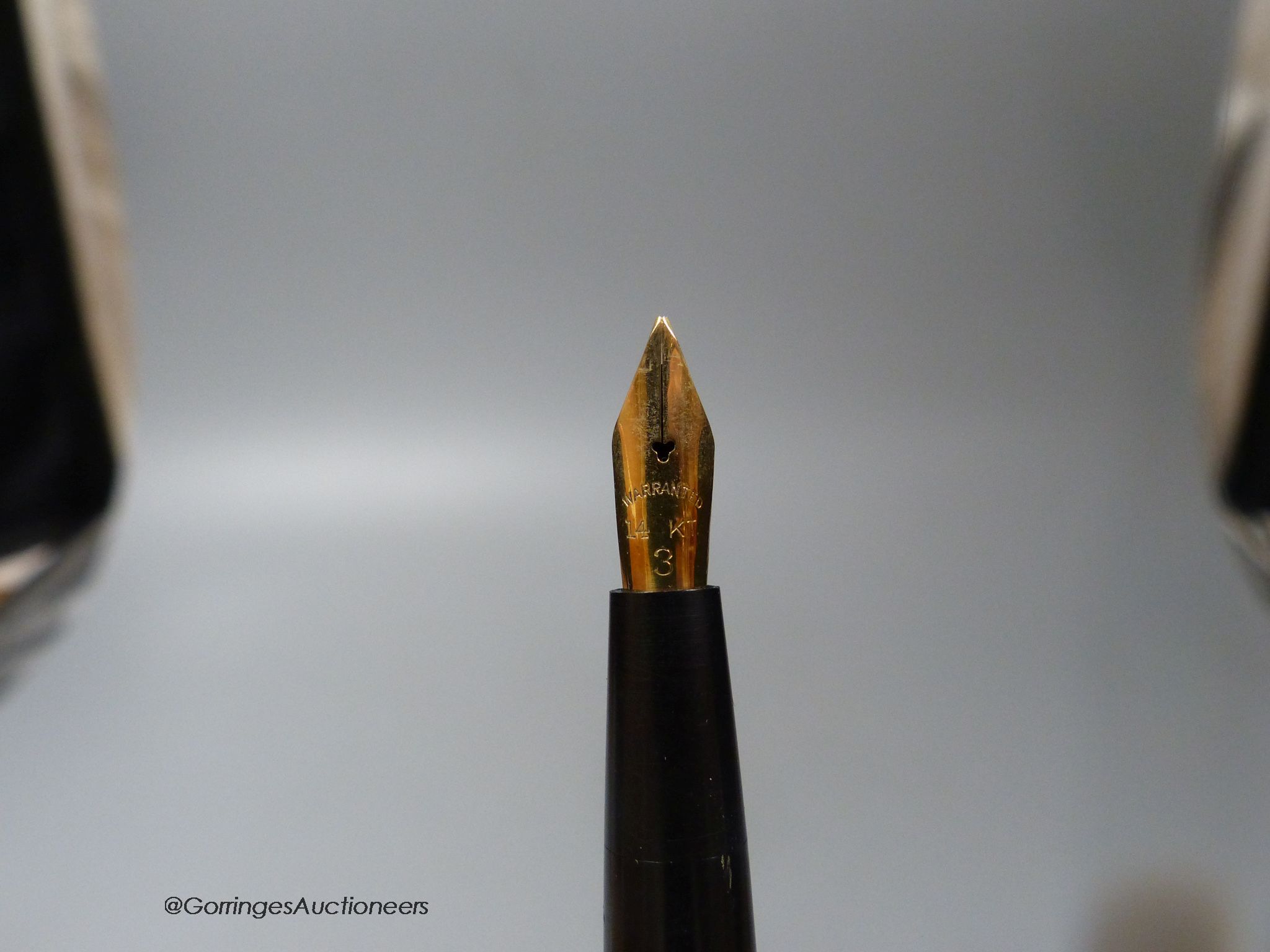 A 1920's gold plated eye-dropper fountain pen